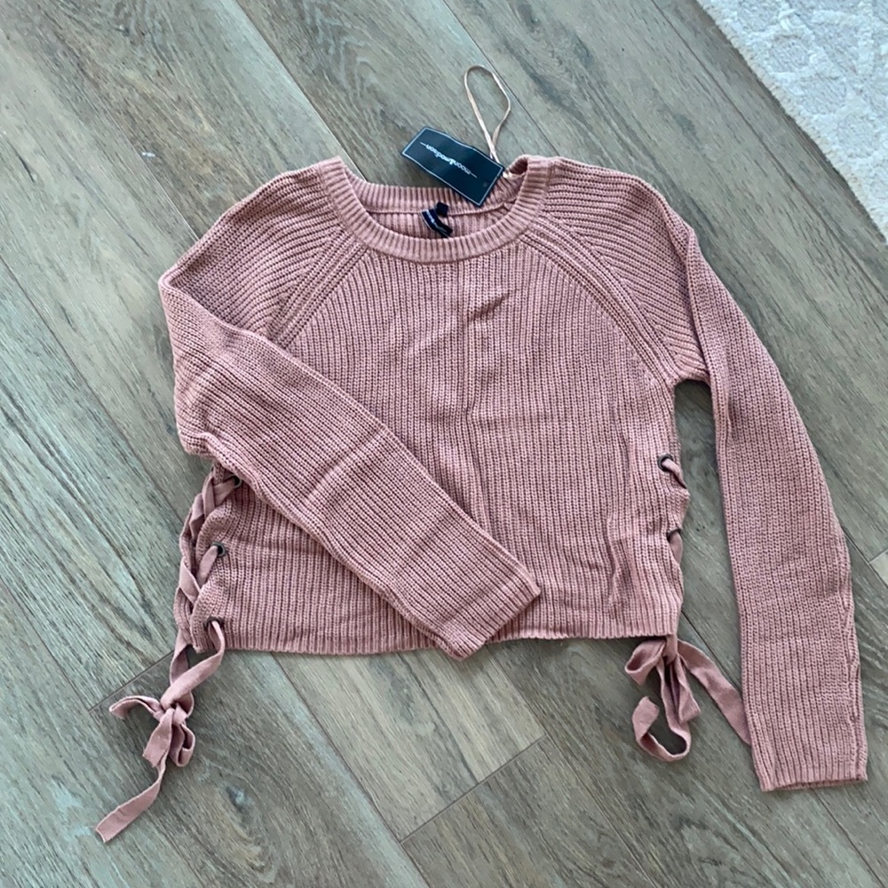 Grand new pink sweater with lace up sides